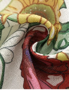 Close-up of semi-blackout linen curtain fabric with vibrant sunflower and rose prints