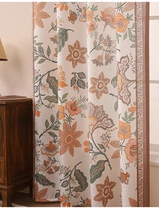 Detailed texture of botanical print linen curtains with intricate geometric lace borders