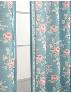 Close-up of modern floral curtains with pink roses, blue background and lace trim