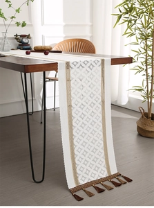 Detailed close-up of Nordic white lace table runner with intricate diamond patterns and tassels