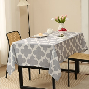 Gray rectangle tablecloth with white Moroccan geometric pattern on a dining table