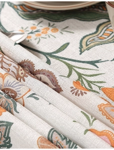 Detail of floral linen tablecloth showing thick texture and bohemian botanical patterns