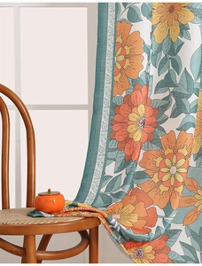 Detail of bohemian floral curtain fabric with orange flowers and woven linen texture
