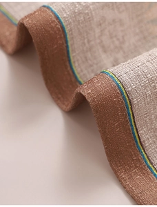 Macro shot of linen-textured curtain fabric with coffee-colored border and colorful stripes