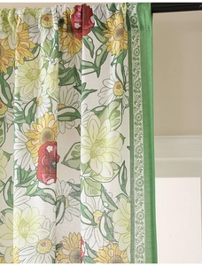 Detail of floral printed linen curtain featuring sunflower patterns and green decorative edge