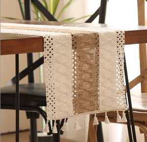 Close-up of Bohemian woven table runner with tassel fringe and diamond knit patterns