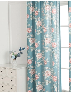 Close-up of modern floral curtains with vintage blue base and pink rose pattern