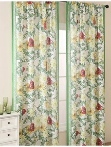 Detail of floral printed curtains with green borders and rod pocket header design