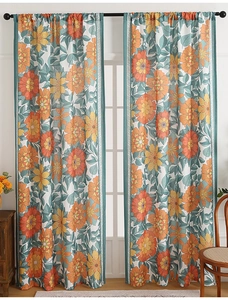 Close-up of bohemian floral curtains with vintage orange yellow blooms and linen texture