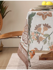 Close-up of thick textured linen tablecloth featuring vintage floral and botanical prints