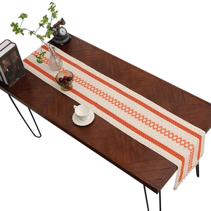 Minimalist cotton linen table runner with orange geometric patterns and white tassels