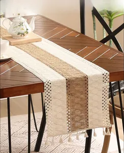 Macro detail of bohemian crochet table runner with tassels and woven cotton texture