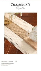 Detailed close-up of handmade hollow-out woven table runner with knotted fringe decoration