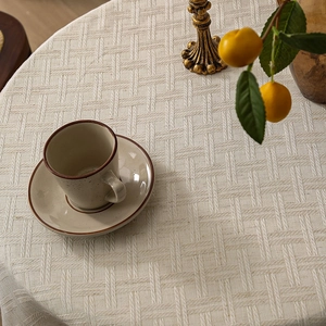 Elegant round beige cotton linen tablecloth with woven texture for afternoon tea