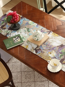 Close-up of impressionist floral oil painting pattern on smooth dining table runner