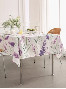 Detailed close-up of lavender floral print on linen texture tablecloth with elegant decor