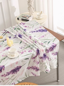 Detail of lavender floral print on white tablecloth with elegant draped edges