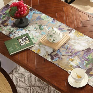 Artistic oil painting floral table runner in purple and blue on a wooden dining table