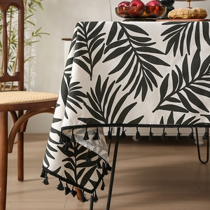Nordic cotton linen tablecloth featuring black palm leaf prints and elegant fringe trim