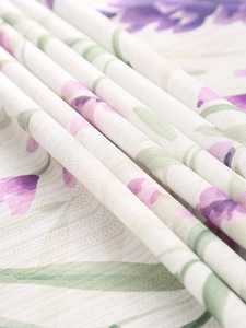 Macro view of lavender floral print on semi-transparent white fabric with soft texture