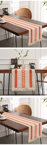Detail of bohemian cotton linen table runner with orange geometric crochet and tassels