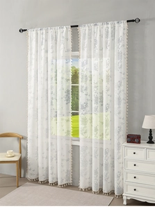 Detail of French lace sheer curtain with butterfly floral patterns and elegant fringe tassels