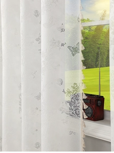 Detail of white butterfly lace sheer curtain featuring elegant flower embroidery and tassels