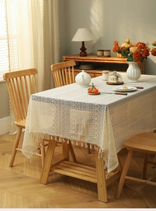 Detail showing vintage French cream lace tablecloth with intricate embroidery and tassels