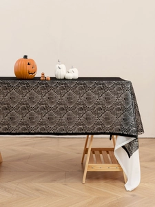 Close-up of black lace Halloween tablecloth with detailed spider web mesh pattern