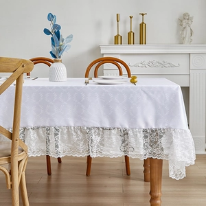 Nordic minimalist white linen tablecloth with elegant lace trim on a wooden dining table