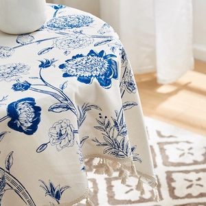 Linen cotton tablecloth with blue floral prints and beige tassels for home decor