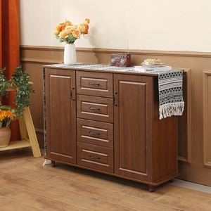 Dark brown wood side cabinet with four drawers, metal handles and woven table runner