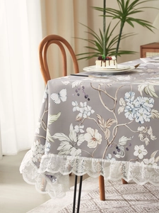 Close-up of vintage floral tablecloth with delicate white lace edge in a cozy home setting