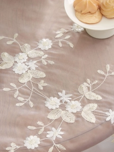 Close-up of white floral embroidery on premium mesh lace tablecloth for dining table