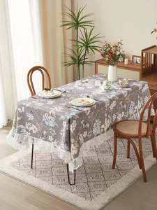 Close-up of vintage floral tablecloth with elegant white lace edges in high-quality fabric