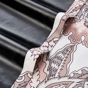 Detail of blackout curtain with high-gloss black coating and floral paisley fabric