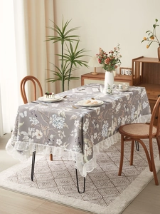 Close-up of vintage floral tablecloth with elegant white lace edge for a cozy tea time