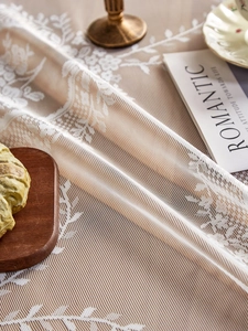 Detailed view of beige hollow lace tablecloth with intricate floral jacquard pattern