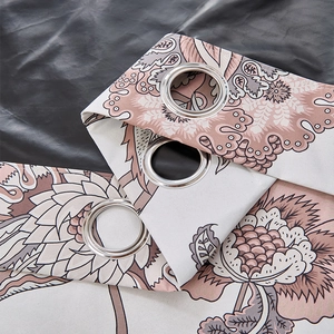Detail of blackout curtain with floral patterns and silver metal grommets for hanging