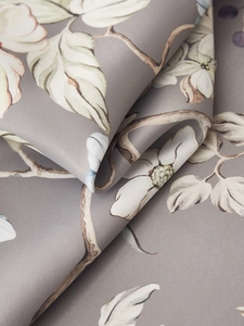 Macro shot of vintage floral pattern on silky gray fabric with elegant drape and texture