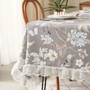 Vintage floral tablecloth with white lace border and elegant butterfly patterns