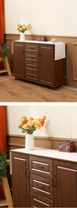 Detail of dark brown wood grain sideboard featuring vintage black metal drawer handles
