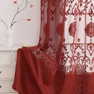 Close-up of luxury deep red lace curtains with vintage baroque pattern texture