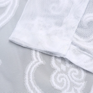 Macro detail of white lace mesh fabric with elegant floral embroidery and neat stitching