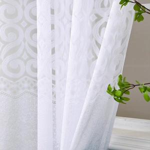Detailed view of white floral lace sheer curtain with elegant embroidery for home decor