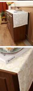 Detailed close-up of premium jacquard table runner with golden floral embroidery patterns