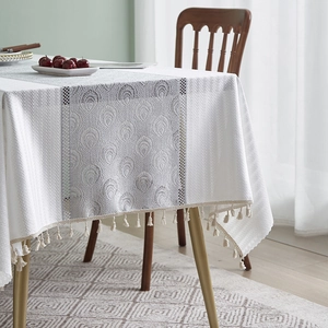 Detail of French cotton linen tablecloth with peacock pattern jacquard and fringe tassels