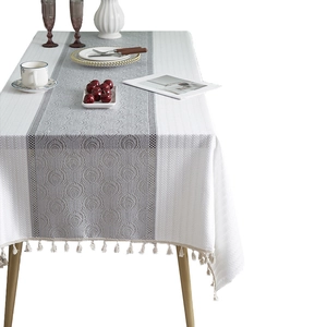 French style grey peacock feather jacquard tablecloth with tassel fringe on a dining table