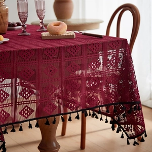 Burgundy hollow crochet tablecloth with diamond pattern and black tassel trim