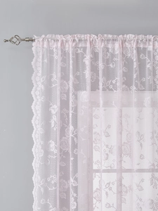 Detail of light pink lace curtain featuring intricate floral patterns and scalloped edges